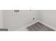 A well-lit laundry room with wood-look flooring and utility connections at 3725 Heron Creek Ct, Loganville, GA 30052