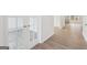 Bright, open-concept room with glass panel french doors, hardwood floor, and view to the kitchen at 3725 Heron Creek Ct, Loganville, GA 30052
