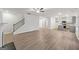 Bright open-plan living room with hardwood floors and stairs leading to the upper level of the house at 3725 Heron Creek Ct, Loganville, GA 30052