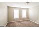 Bright bedroom with neutral walls, plush carpet, and two windows for ample sunlight at 5105 Cascade Hills Cir, Atlanta, GA 30331