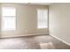 Inviting bedroom featuring neutral walls, plush carpet, and two windows for natural light at 5105 Cascade Hills Cir, Atlanta, GA 30331