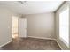 Spacious bedroom with neutral tones, cozy carpet, and a doorway leading to another area at 5105 Cascade Hills Cir, Atlanta, GA 30331