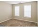 Cozy bedroom with plush carpet, neutral walls, and two windows offering natural light at 5105 Cascade Hills Cir, Atlanta, GA 30331