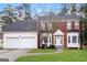 Charming two-story brick home with a well-manicured lawn, a two-car garage and a welcoming front entrance at 5105 Cascade Hills Cir, Atlanta, GA 30331