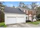 Side view of a two story brick home with attached two car garage and well maintained lawn at 5105 Cascade Hills Cir, Atlanta, GA 30331