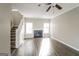 Bright living room featuring a fireplace, wood floors, and a staircase leading to the upper level at 5105 Cascade Hills Cir, Atlanta, GA 30331