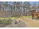 Expansive backyard featuring mature trees and a wooden deck perfect for outdoor entertaining at 208 Pinnacle Ct, Peachtree City, GA 30269
