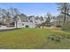 Spacious backyard featuring a two-story white home with a walkout deck and large lawn at 208 Pinnacle Ct, Peachtree City, GA 30269