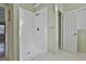 Shower with white tile and neutral bathroom with soaking tub and an entry door at 208 Pinnacle Ct, Peachtree City, GA 30269