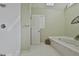 Bathroom featuring walk-in shower, soaking tub, and neutral color palette at 208 Pinnacle Ct, Peachtree City, GA 30269