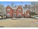 Charming two-story brick home with a well-manicured front yard and classic architectural details at 208 Pinnacle Ct, Peachtree City, GA 30269
