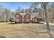Charming two-story brick home with mature trees, a landscaped yard, and a paved driveway at 208 Pinnacle Ct, Peachtree City, GA 30269