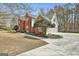 Angle view of a brick home with white siding, an attached three-car garage, and a concrete driveway at 208 Pinnacle Ct, Peachtree City, GA 30269