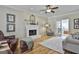 Cozy living room features a fireplace, hardwood floors, and comfortable seating arrangements at 208 Pinnacle Ct, Peachtree City, GA 30269