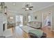 Bright living room with hardwood floors, fireplace, ceiling fan, and access to other rooms at 208 Pinnacle Ct, Peachtree City, GA 30269