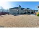 Exterior shot of a home featuring a backyard with covered patio, grill, and green grass at 305 Cranmore Pl, Villa Rica, GA 30180
