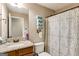 Bathroom featuring patterned shower curtain, neutral paint, stacked towels and granite countertop at 305 Cranmore Pl, Villa Rica, GA 30180