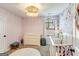 Bright bedroom featuring a white crib, floral wallpaper, and a cozy changing table for a Bedroom at 305 Cranmore Pl, Villa Rica, GA 30180