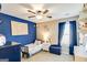 Nautical-themed bedroom featuring blue walls, carpeting, a ceiling fan and plenty of natural light at 305 Cranmore Pl, Villa Rica, GA 30180