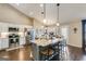 Modern kitchen with a large granite island, stainless steel appliances, and open layout to dining area at 305 Cranmore Pl, Villa Rica, GA 30180