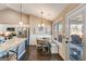 Eat-in kitchen featuring modern stainless appliances, granite countertops, breakfast nook and backyard access at 305 Cranmore Pl, Villa Rica, GA 30180
