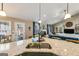 Beautiful kitchen featuring granite countertops, stainless steel sink and open view to the living room at 305 Cranmore Pl, Villa Rica, GA 30180
