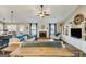 Open-concept living room with a fireplace, built-in bookshelves, and a view to the dining area at 305 Cranmore Pl, Villa Rica, GA 30180