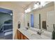 Bathroom featuring double sinks with a marble countertop, and an open doorway to the bedroom at 5997 Wildcreek Rd, Sugar Hill, GA 30518