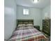 Bedroom with gray walls and carpet featuring neutral colored bedsheets, a window, and a dark wood dresser at 5997 Wildcreek Rd, Sugar Hill, GA 30518
