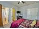Bedroom with a desk and TV featuring carpet flooring and a doorway to an adjacent bathroom at 5997 Wildcreek Rd, Sugar Hill, GA 30518