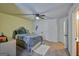 Bedroom featuring a ceiling fan, a bed with storage, a plush carpet, and neutral walls at 5997 Wildcreek Rd, Sugar Hill, GA 30518