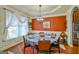 Elegant dining room with large windows, modern chandelier, and seating for eight at 5997 Wildcreek Rd, Sugar Hill, GA 30518