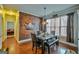 Dining room with wooden accent wall, hardwood floors, and natural light from the windows at 5997 Wildcreek Rd, Sugar Hill, GA 30518