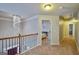 Upstairs hallway with chandelier, and doorway views of bedrooms at 5997 Wildcreek Rd, Sugar Hill, GA 30518