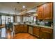 Open kitchen with granite countertops and stainless-steel appliances, with view into living area at 5997 Wildcreek Rd, Sugar Hill, GA 30518