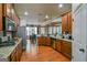 Open concept kitchen with wood flooring and granite countertops, flowing into dining room at 5997 Wildcreek Rd, Sugar Hill, GA 30518