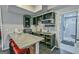 Kitchenette with granite counters, dark cabinetry, bar seating, and convenient access to the bathroom at 5997 Wildcreek Rd, Sugar Hill, GA 30518