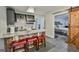 Kitchenette featuring granite counters, dark cabinetry, and bar seating, connecting to a cozy bedroom at 5997 Wildcreek Rd, Sugar Hill, GA 30518