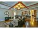 Open-concept living room with hardwood floors, coffered ceilings, and view into the kitchen at 5997 Wildcreek Rd, Sugar Hill, GA 30518