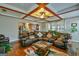 Inviting living room features coffered ceilings, hardwood floors, and a comfortable leather sectional sofa at 5997 Wildcreek Rd, Sugar Hill, GA 30518