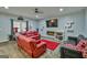 Inviting living room with plush seating, cozy fireplace, and modern entertainment center for relaxation at 5997 Wildcreek Rd, Sugar Hill, GA 30518