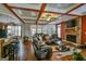 Spacious living room boasts hardwood floors, a stone fireplace, and a large sectional sofa at 5997 Wildcreek Rd, Sugar Hill, GA 30518