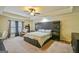 Spacious main bedroom with large bed, sitting area, and ample natural light at 5997 Wildcreek Rd, Sugar Hill, GA 30518