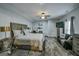 Spacious main bedroom with a ceiling fan, large bed, desk, and a comfortable seating area at 5997 Wildcreek Rd, Sugar Hill, GA 30518