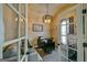 Office featuring french doors, carpet flooring, and a modern chandelier at 5997 Wildcreek Rd, Sugar Hill, GA 30518