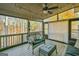 Comfortable screened-in porch with ceiling fan, deck boards, and backyard views at 5997 Wildcreek Rd, Sugar Hill, GA 30518