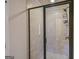 Shower with sliding glass door and tile surround at 5997 Wildcreek Rd, Sugar Hill, GA 30518