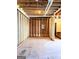 A view of the unfinished basement with exposed wood framing and electrical panel, ready for finishing at 209 East Wilson St # 25, Villa Rica, GA 30180
