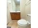 Bathroom features a wooden vanity, tile flooring, framed mirror and white toilet at 209 East Wilson St # 25, Villa Rica, GA 30180