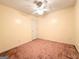 An empty bedroom features neutral walls, neutral carpet, and ceiling fan at 209 East Wilson St # 25, Villa Rica, GA 30180